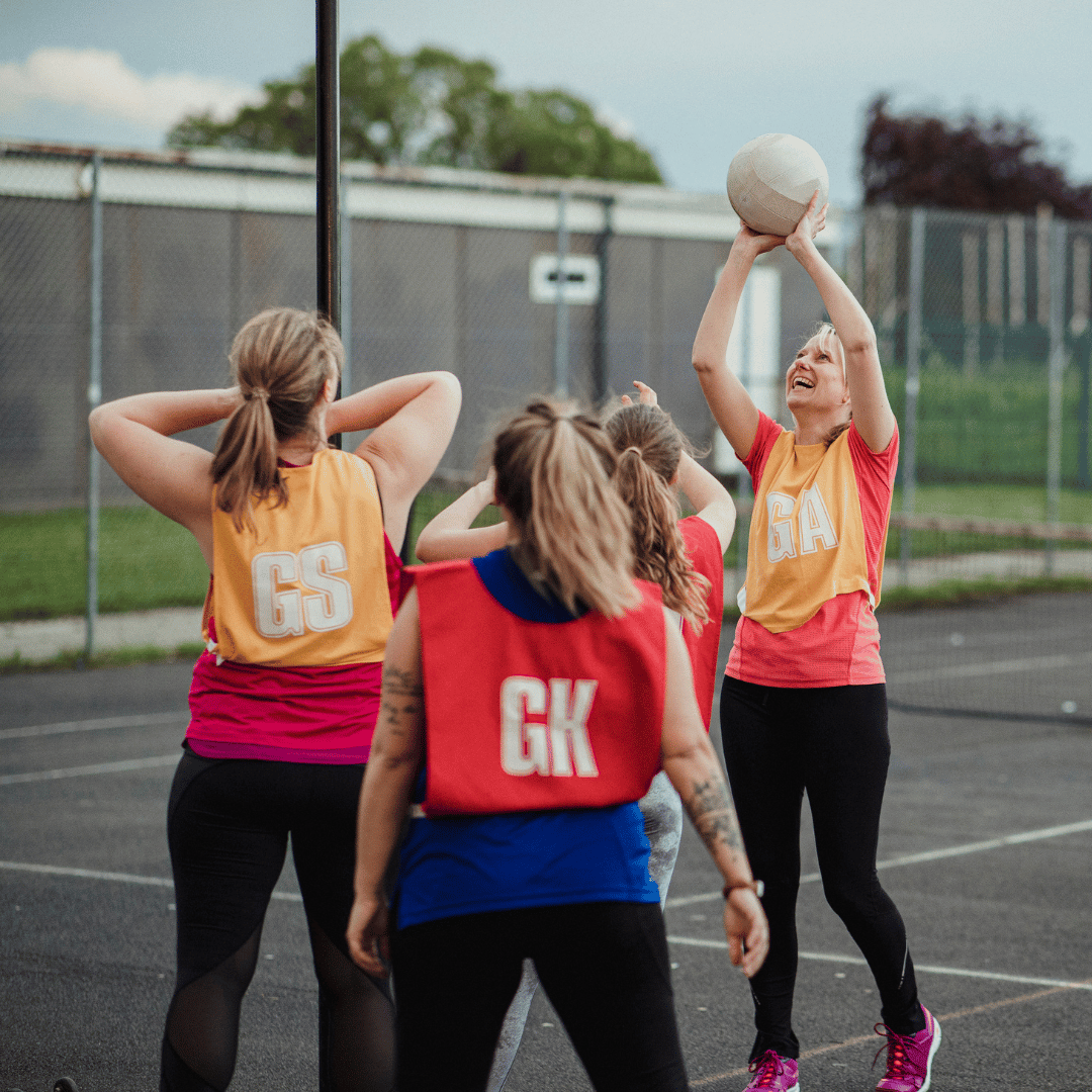 hybrid-collaboration_netball A netball team working together to score a goal