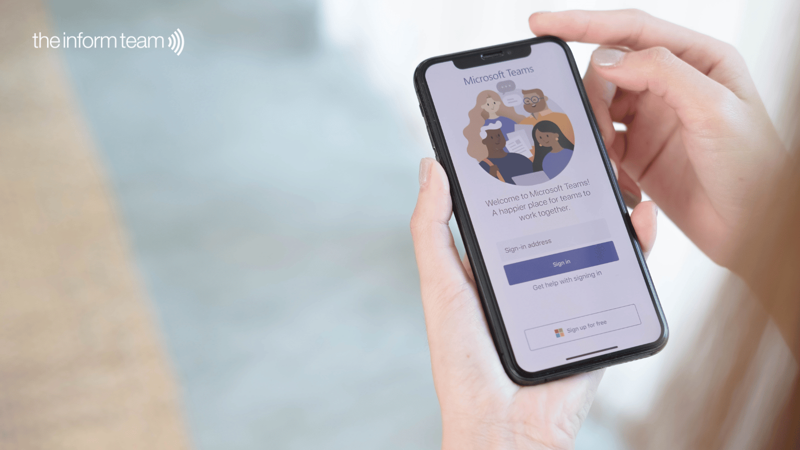 7-signs-M365-potential A hand holding a mobile device with the Microsoft Teams interface on screen