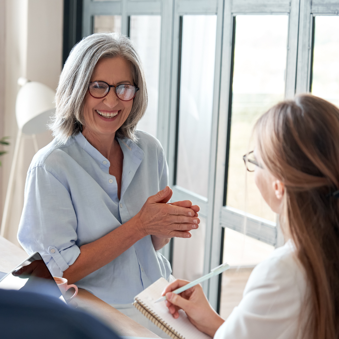 Change management burger – Exec coaching Two women wearing glasses facing one another