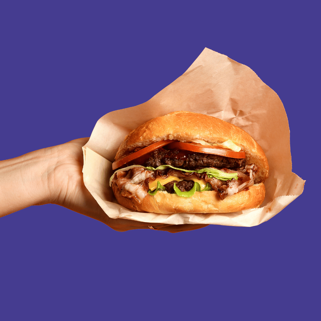 Change management burger recipe 1 – Excite A hand holding a burger on a purple background