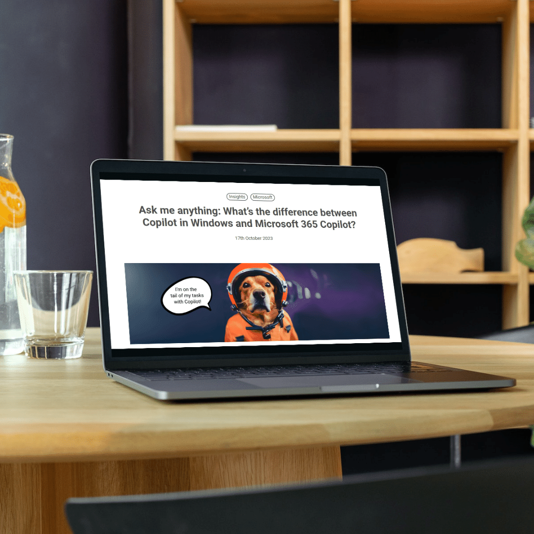 summarise-blog a laptop on a wooden table with an empty glass and bottle of water containing sliced lemons