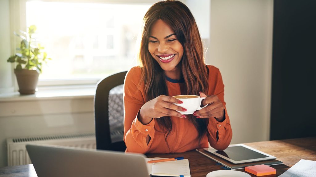 copilot-for-wellbeing Woman pauses to enjoy a cup of coffee at work
